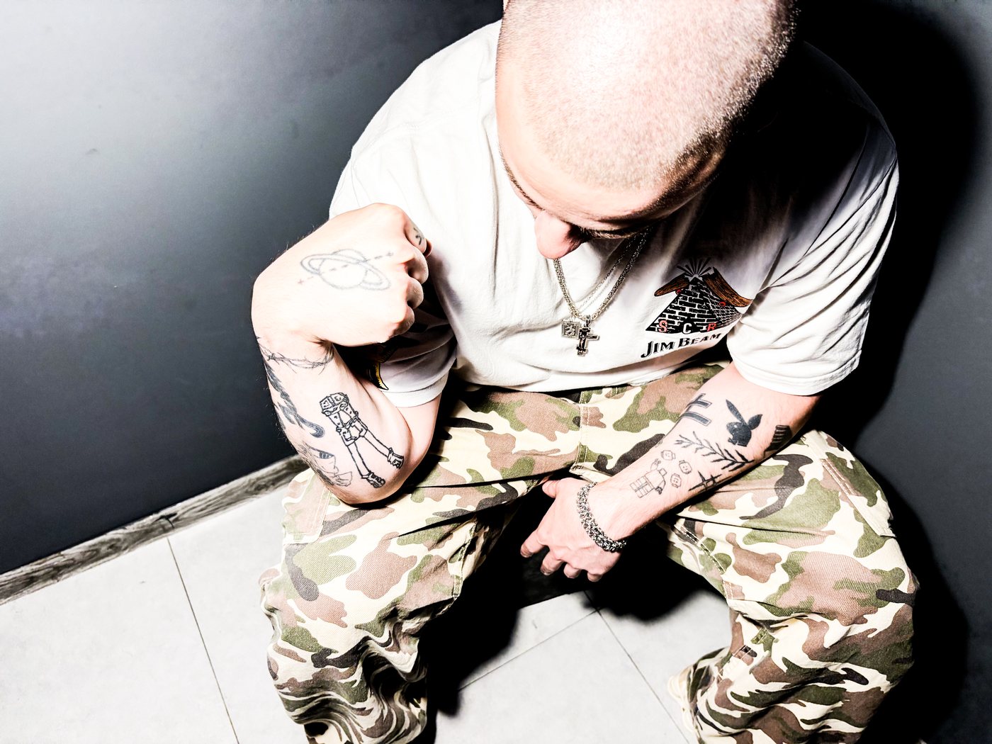 arm tattoos, seated, shot from above